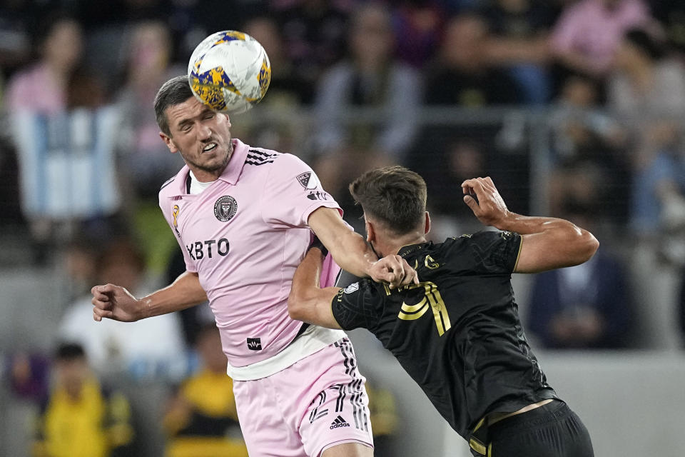 Inter Miami defender Serhiy Kryvtsov, left, heads the ball as Los Angeles FC midfielder Mateusz Bogusz reaches in during the first half of a Major League Soccer match Sunday, Sept. 3, 2023, in Los Angeles. (AP Photo/Mark J. Terrill)