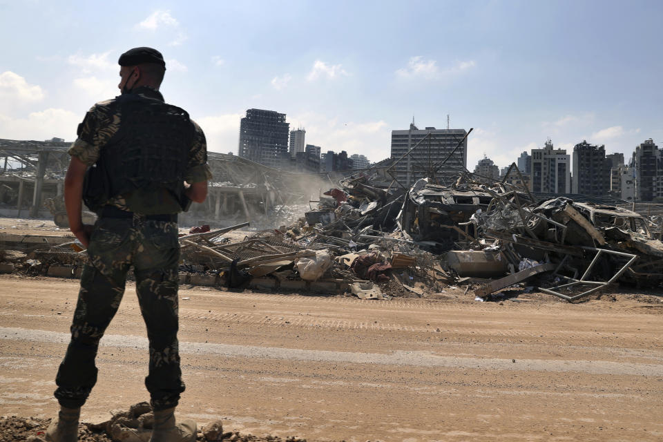 A Lebanese army soldier stands guard at the site of the Aug. 4 explosion that hit the seaport of Beirut, Lebanon, Saturday, Aug. 15, 2020. (AP Photo/Bilal Hussein)