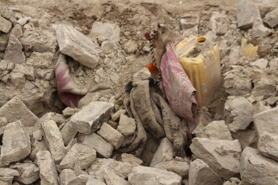 Belongings are seen inside a damaged house after that was damaged by Monday's earthquake in the remote western province of Badghis, Afghanistan, Tuesday, Jan. 18, 2022. The United Nations on Tuesday raised the death toll from Monday's twin earthquakes in western Afghanistan, saying three villages of around 800 houses were flattened by the temblors. (Abdul Raziq Saddiqi)