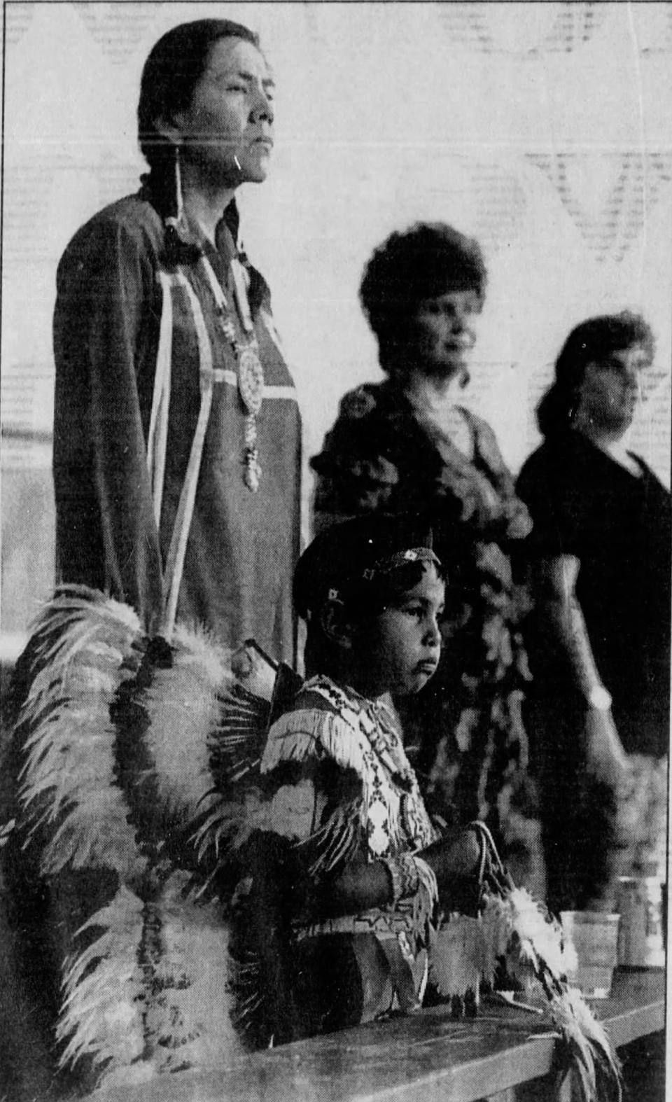 Benjamin Anton (foreground) and his mother, Denise Alley, listen as a powwow circle near the gaming center at the Fort McDowell Mohave-Apache Indian Community is blessed at the start of a 10-day powwow last week. (Published May 17, 1992) (AP Photo/Scott Troyanos)
