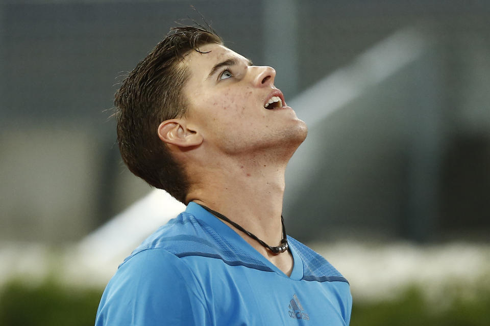 Dominic Thiem from Austria look up as he celebrates his victory during a Madrid Open tennis tournament match against Stanislas Wawrinka from Switzerland, in Madrid, Spain, Tuesday, May 6, 2014. (AP Photo/Andres Kudacki)