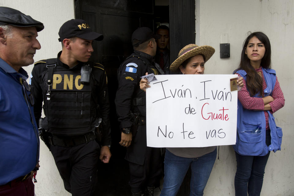 Supporters of Commissioner Ivan Velasquez hold a sign in front of the United Nations International Commission Against Impunity, CICIG, headquarters in Guatemala City, Friday, Aug. 31, 2018. Guatemala president Jimmy Morales says he is not renewing mandate of U.N.-sponsored commission investigating corruption in the country. (AP Photo/Moises Castillo)