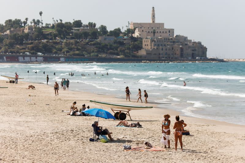 FILE PHOTO: People hang out at the Mediterranean beach near Jaffa as coronavirus disease (COVID-19) restrictions ease in Tel Aviv