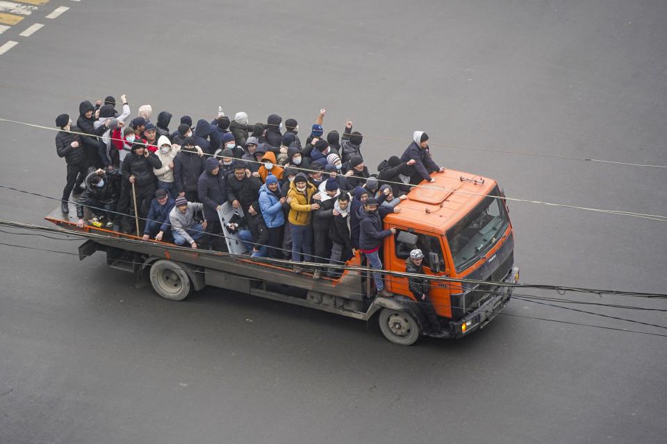 FILE - Demonstrators ride a truck during a protest in Almaty, Kazakhstan, Wednesday, Jan. 5, 2022. Demonstrators denouncing the doubling of prices for liquefied gas have clashed with police in Kazakhstan's largest city and held protests in about a dozen other cities in the country. (Vladimir Tretyakov/NUR.KZ via AP, File)
