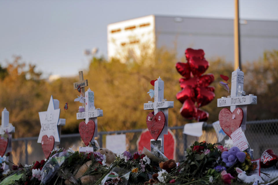 FILE- In this Feb. 19, 2018, file photo a makeshift memorial is seen outside the Marjory Stoneman Douglas High School, where 17 students and faculty were killed in a mass shooting in Parkland, Fla. There have been more than 415 incidents of gunfire on U.S. school grounds since 2013, according to Every Town for Gun Safety, a nonprofit aimed at reducing domestic gun violence. Last year’s carnage at Marjory Stoneman Douglas High School surpassed the 1999 Columbine High School massacre as the deadliest high school shooting in U.S. history. (AP Photo/Gerald Herbert, File)