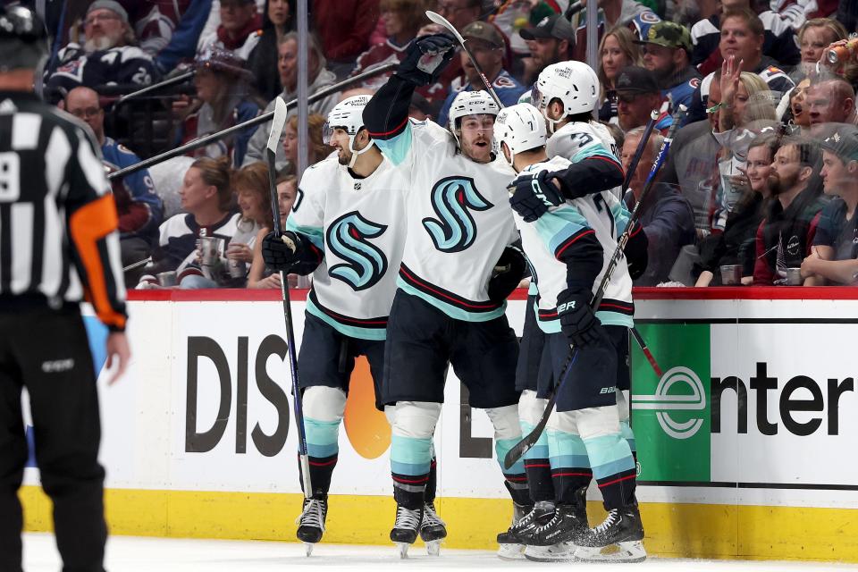 Tye Kartye celebrates with Matty Beniers, Will Borgen, and Jordan Eberle after scoring against the Colorado Avalanche in the second period of Game 5 of the 2023 Stanley Cup Playoffs at Ball Arena on April 26 in Denver.