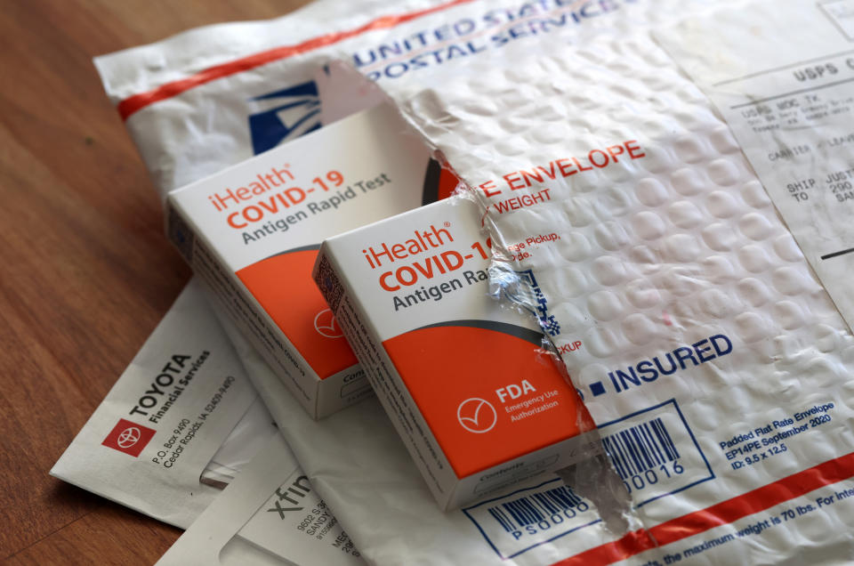 iHealth COVID-19 testing kits in a USPS envelope.