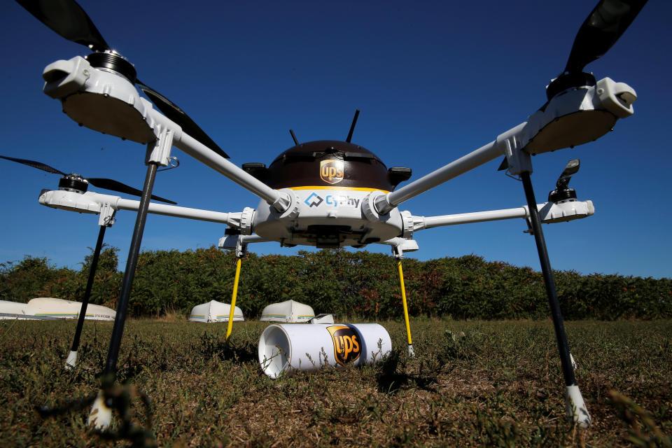 A drone, made by CyPhy Works, stands over the UPS package it carried to Children's Island off the coast of Beverly, Massachusetts, U.S. September 22, 2016, during UPS's demonstration of a drone making a commercial delivery of a package to a remote or difficult-to-access location. Picture taken September 22, 2016. REUTERS/Brian Snyder 