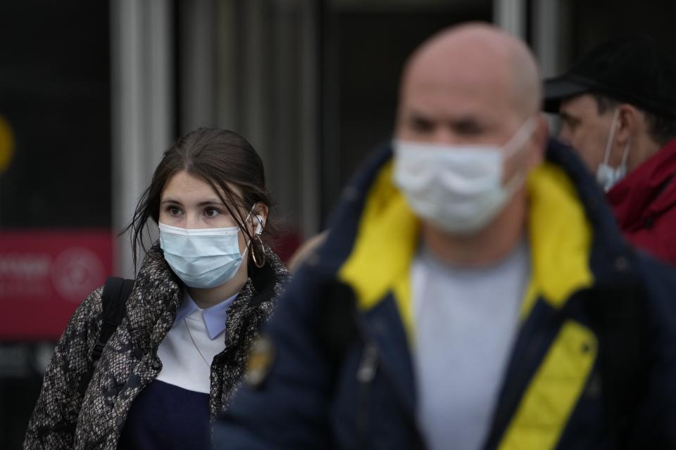 People wearing face masks to help curb the spread of the coronavirus leave a subway in Moscow, Russia, Friday, Oct. 15, 2021. Russia's daily tolls of coronavirus infections and deaths have surged to another record in a quickly mounting figure that has put a severe strain on the country's health care system. The record for daily COVID-19 deaths in Russia has been broken repeatedly over the past few weeks as fatalities steadily approach 1,000 in a single day. (AP Photo/Alexander Zemlianichenko)