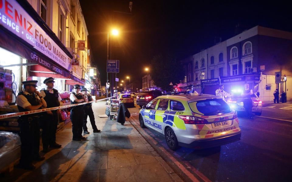 Police man a cordon at Finsbury Park in north London - Credit: PA