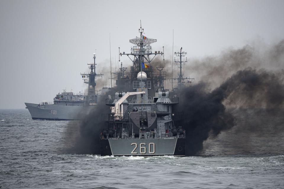 A Romanian warship sails engulfed in smoke during a Romanian Navy led exercise outside Constanta, Romania, Tuesday, April 16, 2024. The exercise, dubbed "Sea Shield 2024," brought together U.S. and NATO troops and involved some 2,200 military personnel from 12 allied and partner states. (AP Photo/Andreea Alexandru)