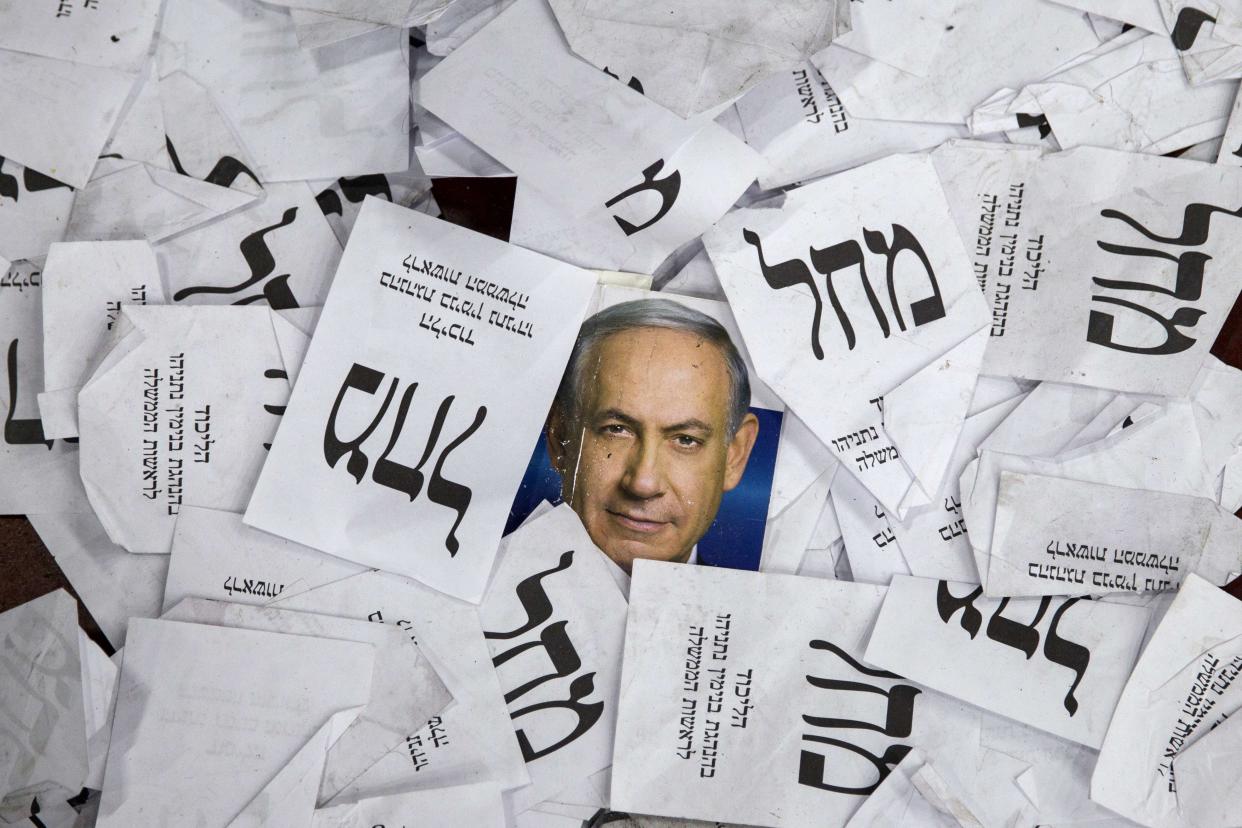 Copies of ballots papers and campaign posters for Israel's Prime Minister Benjamin Netanyahu's Likud Party lie on the ground in the aftermath of the country's parliamentary elections, early on March 18, 2015 in Tel Aviv. On Sunday,  Israel's parliament is poised to cast a historic vote that could end Benjamin Netanyahu's 12-year tenure as prime minister.