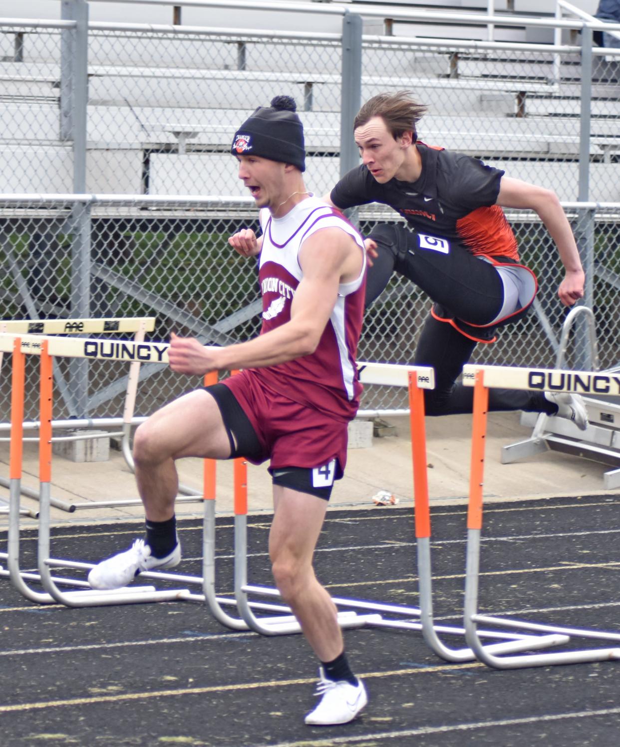 Union City's Nathaniel Maurer leads Quincy's Clayton Benson at the midway point of the 110 meter hurdles on Wednesday. Maurer went on to take first, Benson finished second.