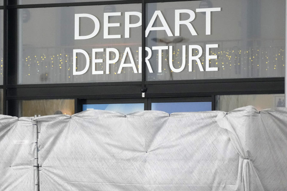 Canvas prevent to see inside the Vatry airport, Saturday, Dec. 23, 2023 in Vatry, eastern France. About 300 Indian citizens heading to Central America were sequestered in a French airport for a third day Saturday because of an investigation into suspected human trafficking, authorities said. The 15 crew members of the Legend Airlines charter flight en route from United Arab Emirates to Nicaragua were questioned and released, according to a lawyer for the small Romania-based airline. (AP Photo/Christophe Ena)