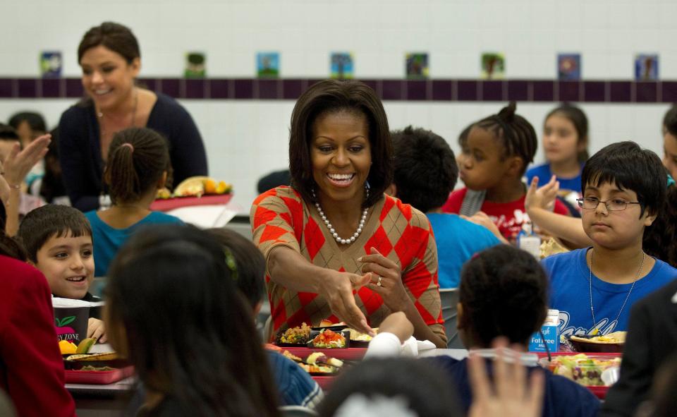 First lady Michelle Obama has lunch with schoolchildren at Parklawn Elementary School in Alexandria, Va., in 2012. Celebrity cook Rachael Ray is on the left.