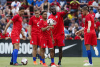 United States midfielder Duane Holmes, center, and forward Jozy Altidore, center right, meet on the field during warmups before an international friendly soccer match against Venezuela, Sunday, June 9, 2019, in Cincinnati. (AP Photo/John Minchillo)