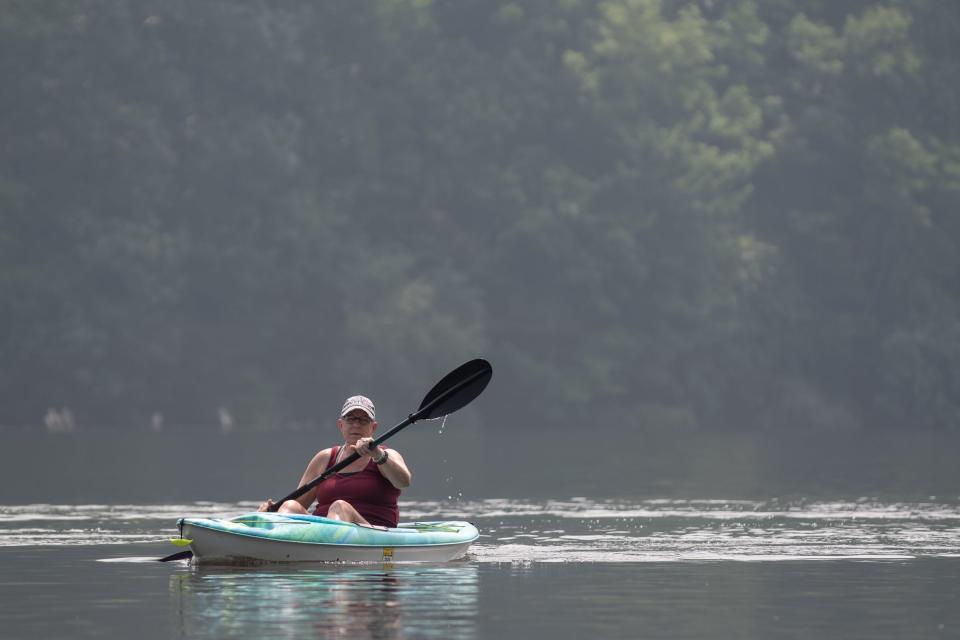 Lisa Wood, of Macungie, kayaks across Lake Nockamixon in Haycock on Thursday, June 29, 2023.