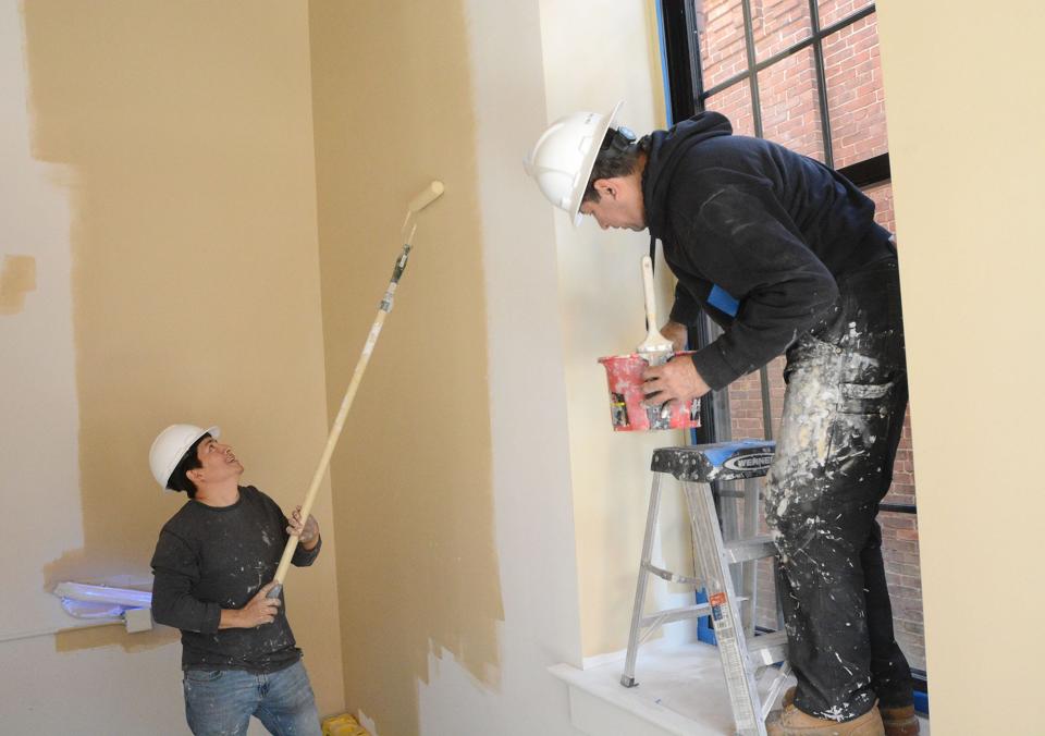 Painters Edwin Montenegro of Clinton, left, and Raul Brito of Old Lyme paint a foyer entrance Wednesday as apartments near completion in Phase III at The Lofts at Ponemah Mills in the Taftville section of Norwich.