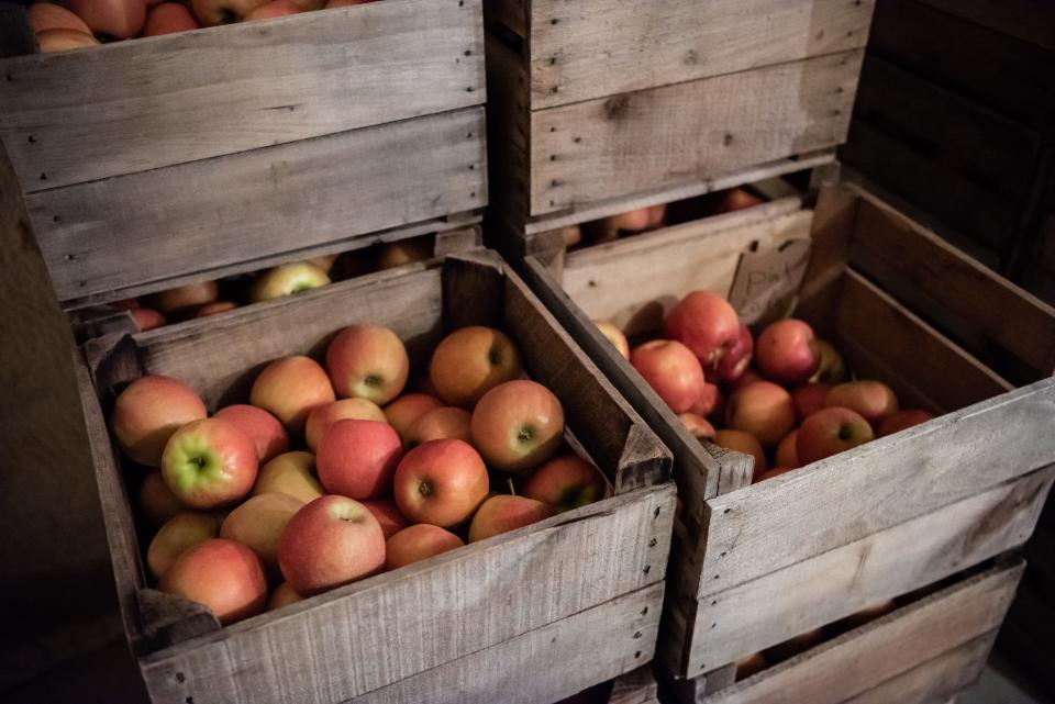 Crates of Pink Lady apples sit in stacks inside a cooler room at Manoff Market Cidery in Solebury Township on Thursday, May 26, 2022.