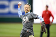 Shigeo Yamada, ambassador of Japan to the United States, throws out a ceremonial first pitch before a baseball game between the Washington Nationals and the Philadelphia Phillies, Saturday, April 6, 2024, in Washington. (AP Photo/Nick Wass)