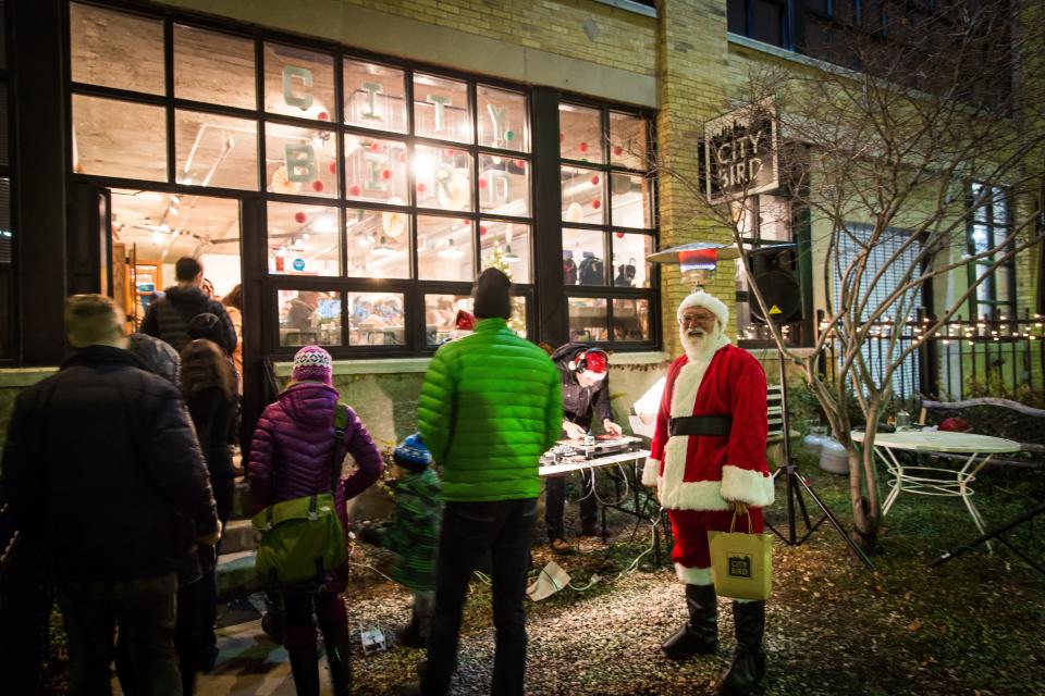 Santa greeting customers at City Bird during Noel Night.