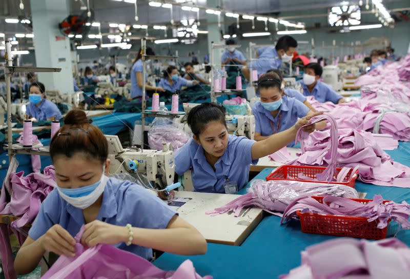 FILE PHOTO: Labourers work at a garment assembly line of Thanh Cong textile, garment, investment and trading company in Ho Chi Minh city