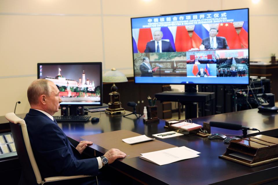 Russian President Vladimir Putin takes part in a virtual unveiling of a nuclear power plant in China together with Chinese President Xi Jinping via video conference at the Novo-Ogaryovo residence outside Moscow, Russia, Wednesday, May 19, 2021. Russian President Vladimir Putin and Chinese President Xi Jinping are on the display) (Sergei Ilyin, Sputnik, Kremlin Pool Photo via AP)