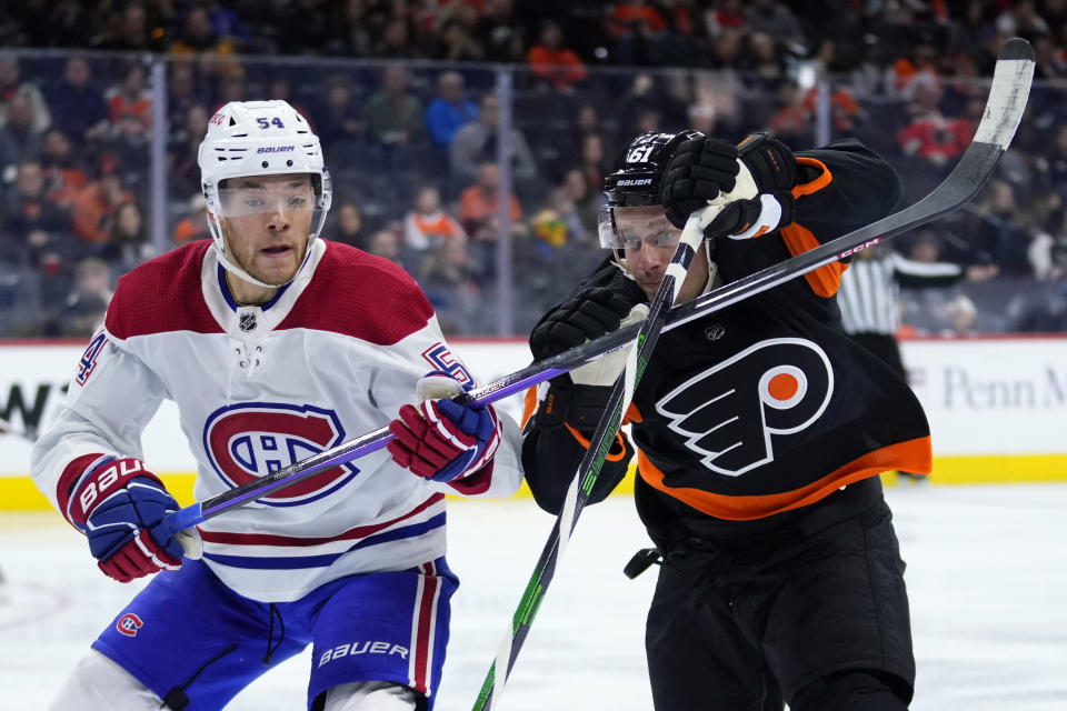 Montreal Canadiens' Jordan Harris, left, and Philadelphia Flyers' Justin Braun battle for position during the second period of an NHL hockey game, Friday, Feb. 24, 2023, in Philadelphia. (AP Photo/Matt Slocum)