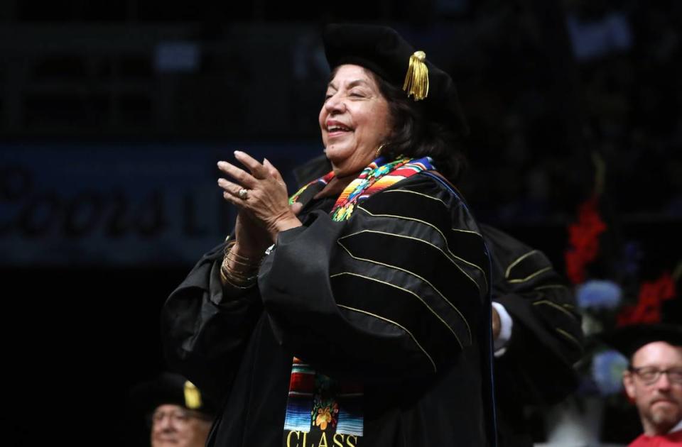 Fresno Arts Council executive director Lilia Gonzales-Chávez, who received an honorary doctorate in the arts, dances to Mexican music at the 48th Fresno State Chicano/Latino Commencement Celebration at the Save Mart Center on May 18, 2024.