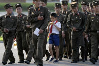 <p>A schoolboy walks among soldiers at the end of a workday July 25, 2017, in Pyongyang, North Korea. (Photo: Wong Maye-E/AP) </p>