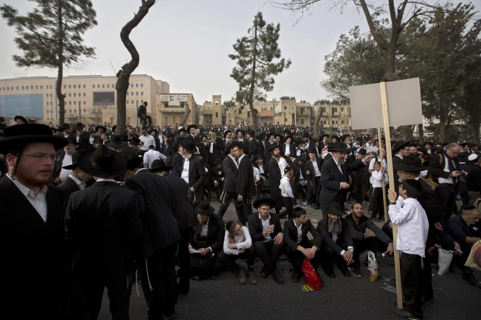 Hundreds of thousands of ultra-Orthodox Jews rally in a massive show of force against plans to force them to serve in the Israeli military, blocking roads and paralyzing the city of Jerusalem, Sunday, March 2, 2014. The widespread opposition to the compulsory draft poses a challenge to the country, which is grappling with a cultural war over the place of the ultra-Orthodox in Israeli society. With secular Jews required to serve, the issue is one of the most sensitive flashpoints between Israel's secular majority and its devout minority. (AP Photo/Sebastian Scheiner)