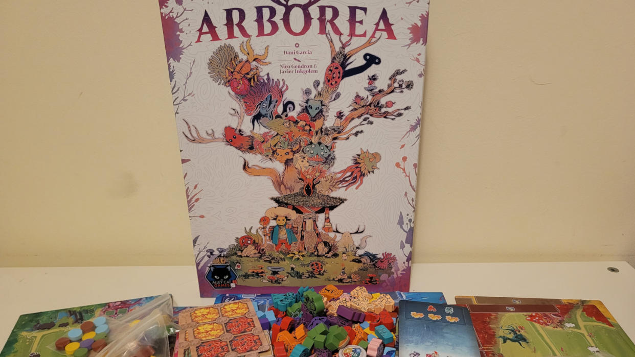 Arborea box and components laid out on a table, against a cream-colored wall. 