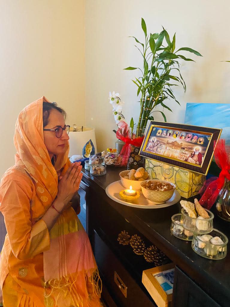 Komaljeet Kaur Johal, a member of the St. John's-area Sikh community, prays to Guru Nanak and other important spiritual teachers of Sikhism. Lighted candles and halwa, a sweet dish made of butter and wheat flour, mark the special day. 