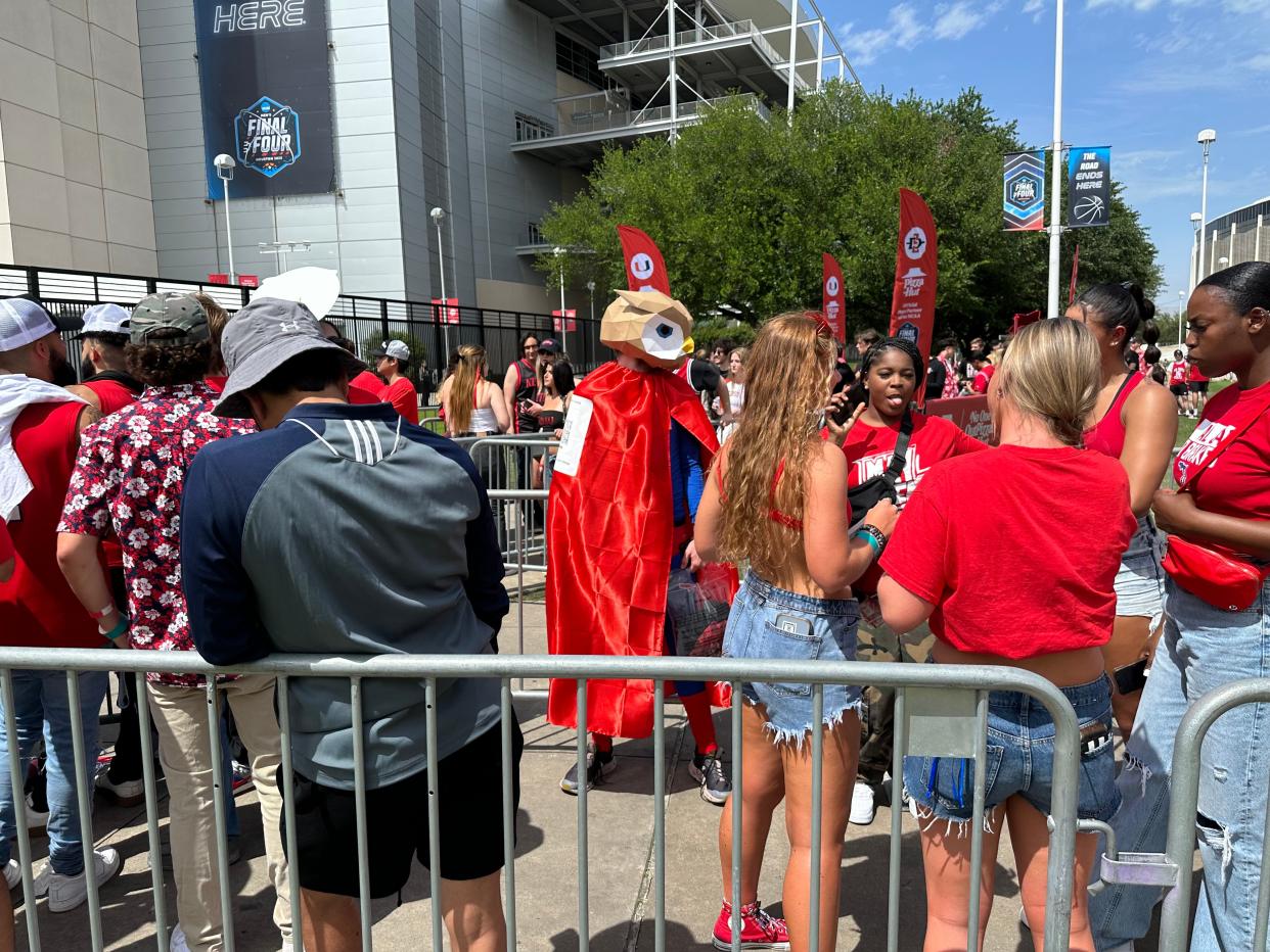 FAU basketball fans mingle out side Houston's NRG Stadium before Saturday's Final Four semifinal between the Owls and San Diego State.