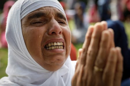 A Kashmiri woman cries during the Eid-al-Adha prayers at a mosque during restrictions after the scrapping of the special constitutional status for Kashmir by the Indian government, in Srinagar