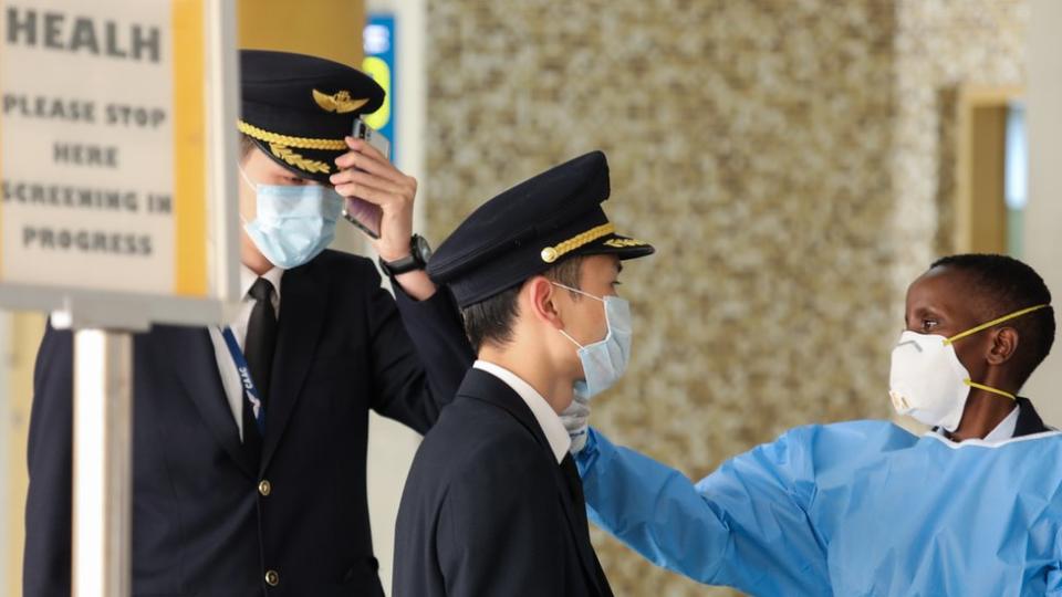 Pilots have their temperatures checked at an airport in Nairobi