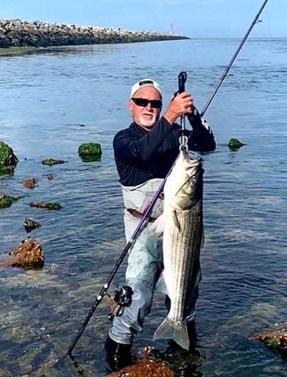 Kenny Nevens of Sagamore, Mass., with the 29-pound striped bass he caught with a white FishLab lure on an east flood tide at the Cape Cod Canal during a full moon tide.