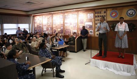 U.S. President Barack Obama and First Lady Michelle Obama (R) greet U.S. military personnel at Marine Corps Base Hawaii on Christmas Day in Kaneohe Bay, Hawaii December 25, 2014. REUTERS/Gary Cameron