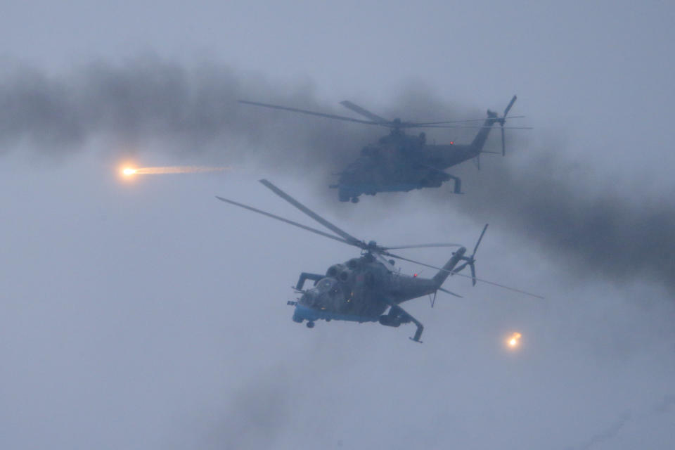 Military helicopters fly over the Osipovichi training ground during the Union Courage-2022 Russia-Belarus military drills near Osipovichi , Belarus, Thursday, Feb. 17, 2022. Russia has deployed troops to its ally Belarus for sweeping joint military drills that run through Sunday, fueling Western concerns that Moscow could use the exercise to attack Ukraine from the north. (AP Photo/Alexander Zemlianichenko Jr)