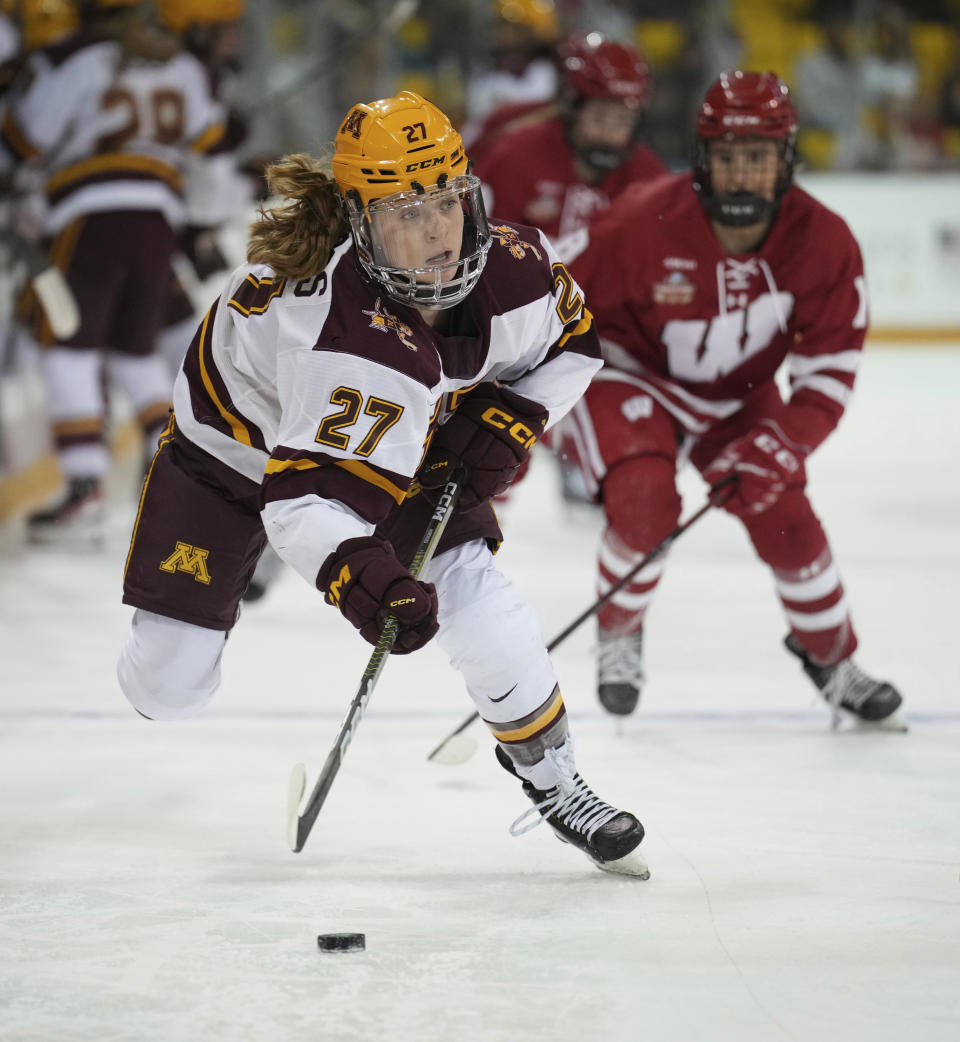 Minnesota forward Savannah Norcross (27) moves the puck against Wisconsin in the first period of a national semifinal in the women's NCAA Frozen Four college hockey tournament in Duluth, Minn., Friday, March 17, 2023. (Shari L. Gross/Star Tribune via AP)