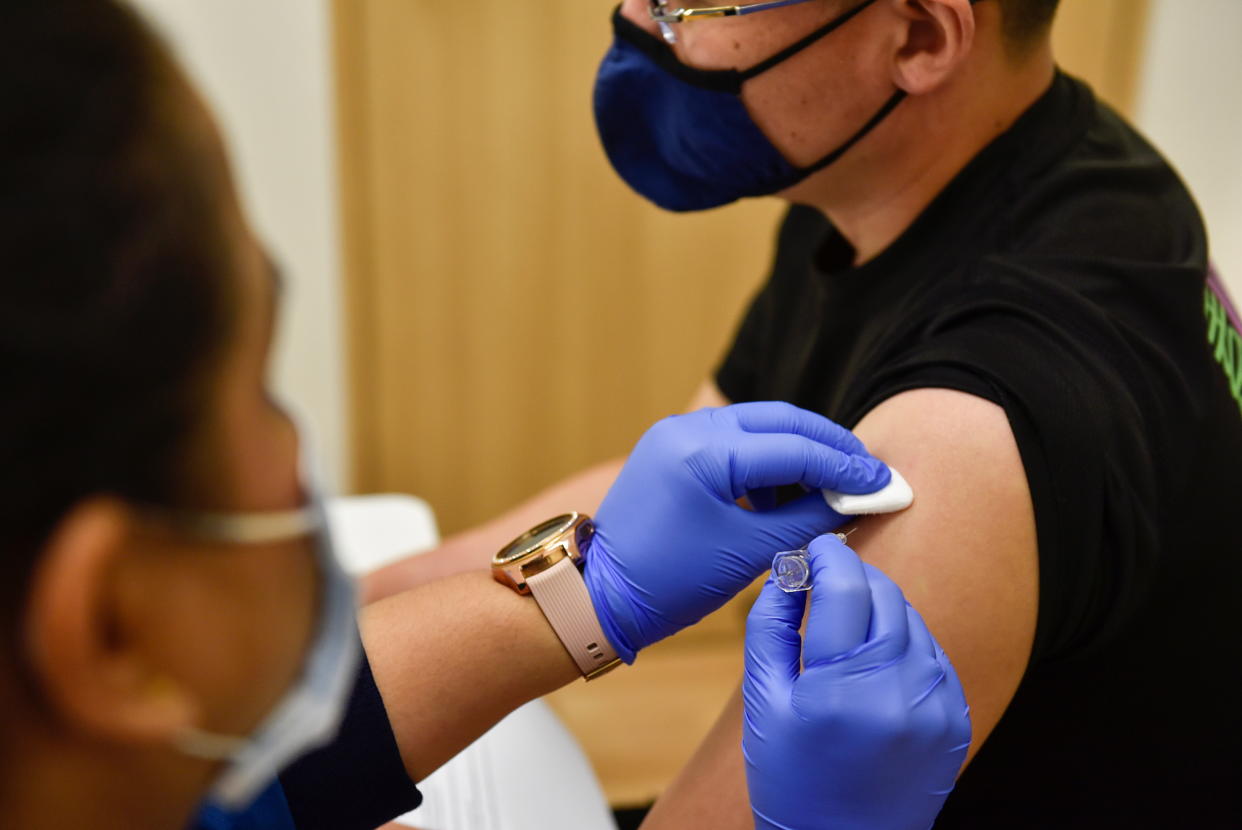 A nurse at StarMed Specialist Centre administers the Sinovac vaccine in Singapore. 