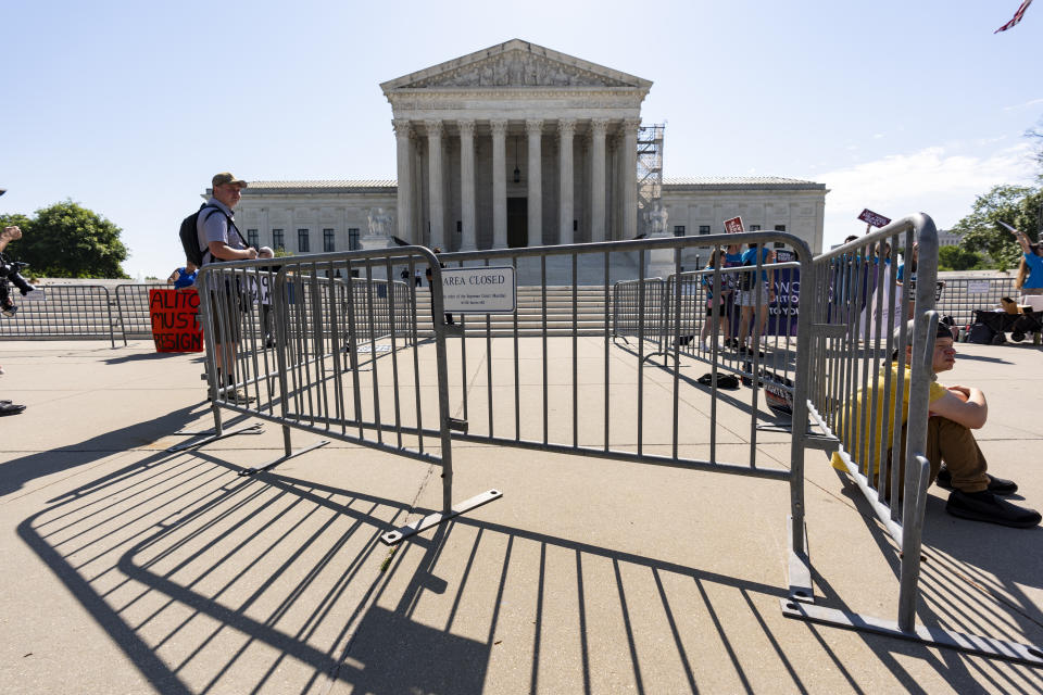 Activists wait as the Supreme Court announces decisions, on Capitol Hill in Washington, Friday, June 21, 2024. The justices are also still weighing whether former President Donald Trump is immune from criminal prosecution in the election interference case against him, roughly two months after hearing arguments. (AP Photo/J. Scott Applewhite)