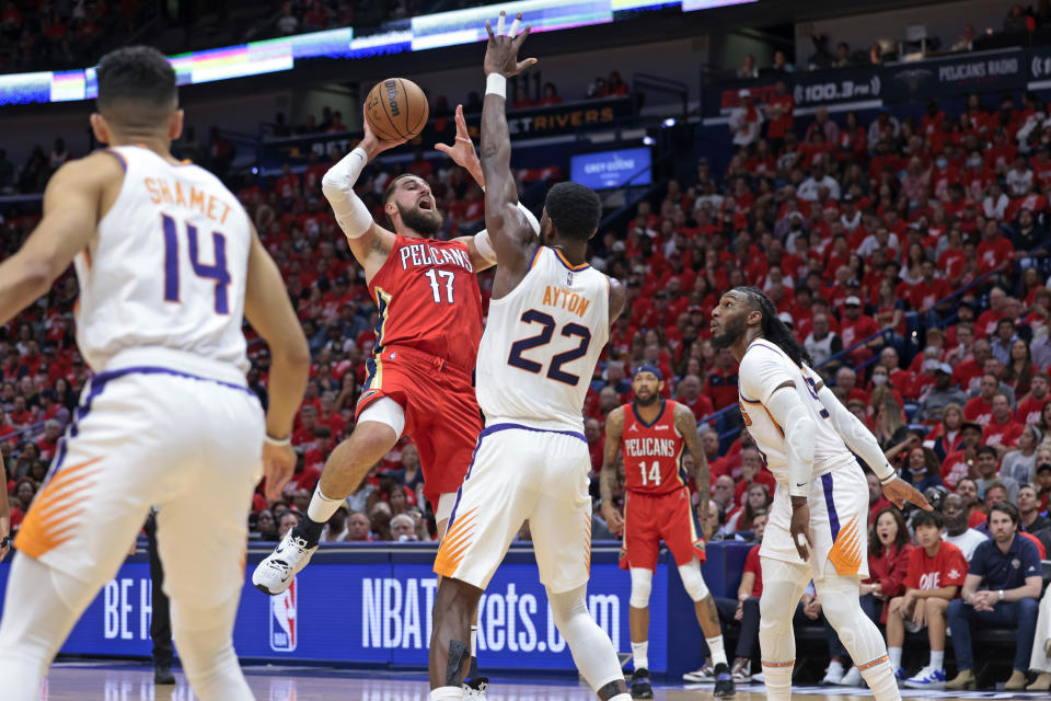 New Orleans Pelicans center Jonas Valanciunas (17) is fouled by Phoenix Suns center Deandre Ayton (22) during the first half of Game 3 of an NBA basketball first-round playoff series in New Orleans, Friday, April 22, 2022. (AP Photo/Michael DeMocker)