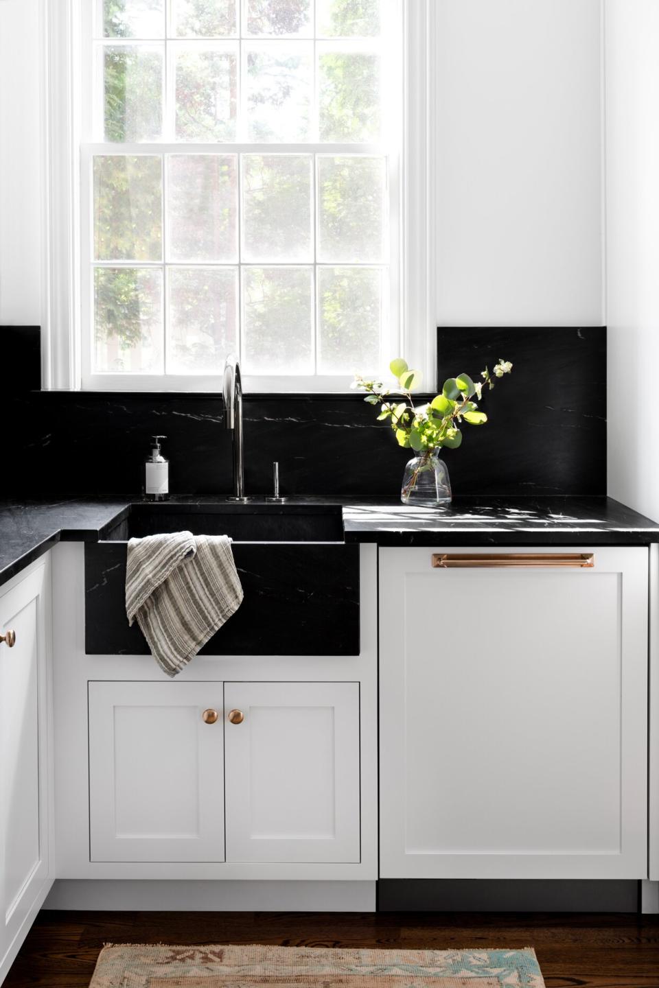 deep black marble kitchen sink white cabinets