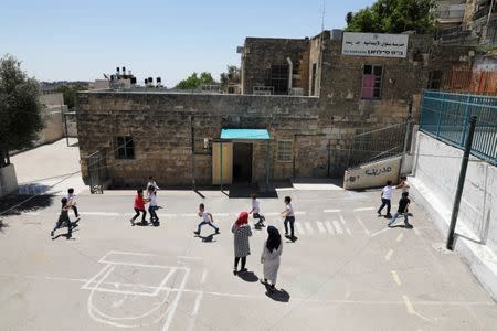 Palestinian children play on a court at a school in the East Jerusalem neighbourhood of Silwan June 19, 2017. REUTERS/Ammar Awad