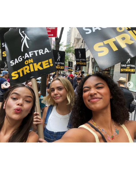 the cast outside joining the picket line