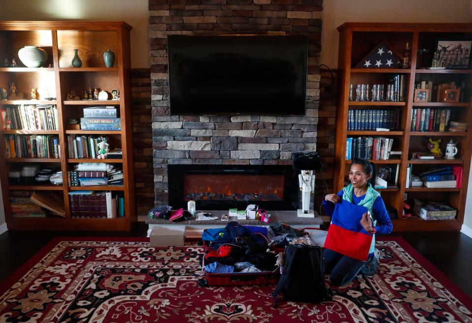 Maria Shircel shows off Philippine flag she will be bringing to her race in Antarctica before packing it away again at Maria Shircel Realty in Clarksville, Tenn., on Wednesday, Jan. 12, 2022. 