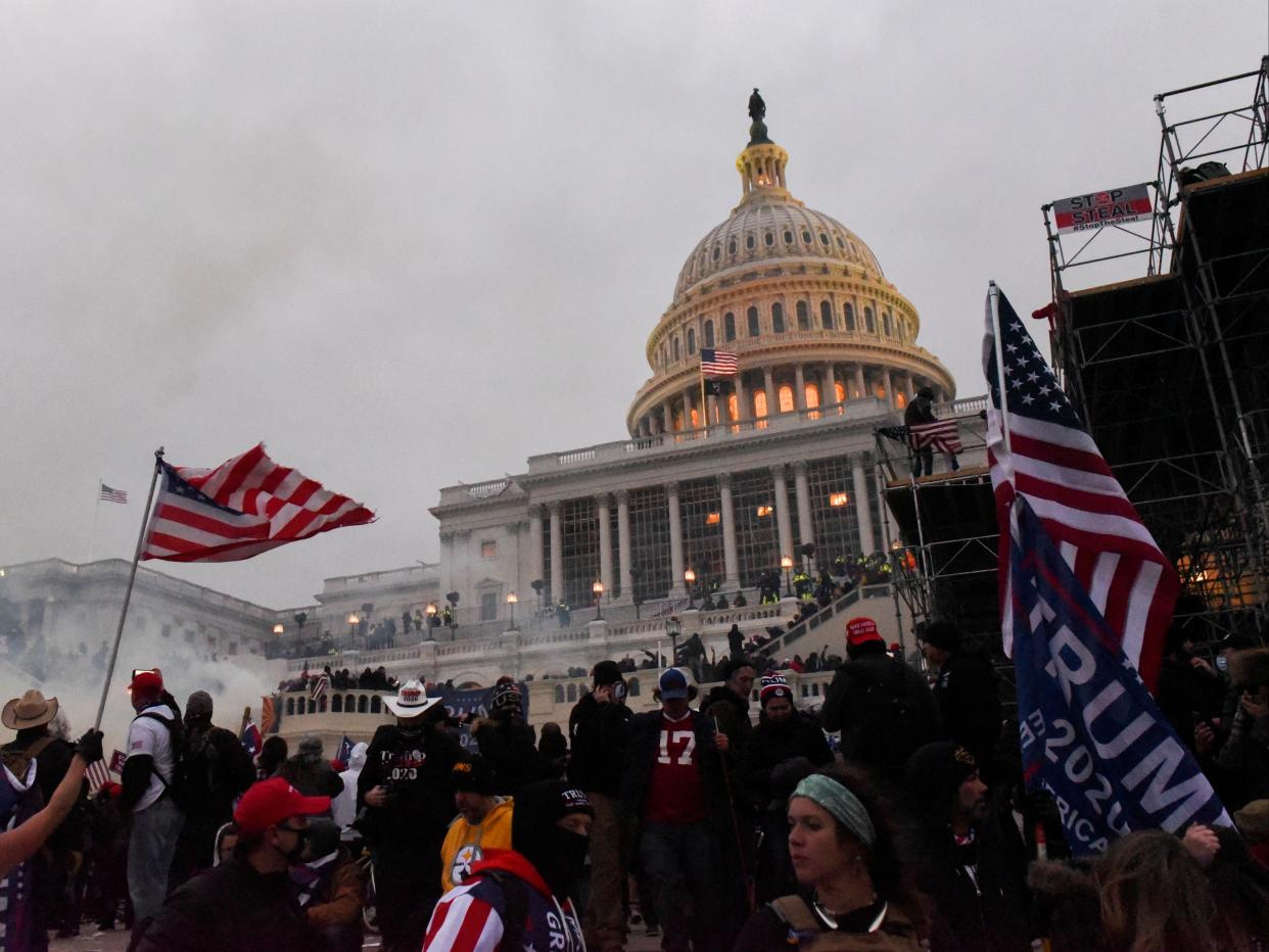 Police attempt to clear the US Capitol Building with tear gas as supporters of US President Donald Trump gather outside, in Washington, 6 January 2021 (REUTERS)