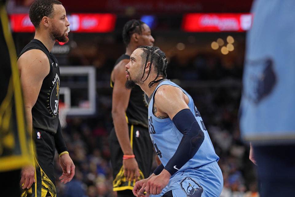 Dillon Brooks of the Memphis Grizzlies gets in the face of Stephen Curry of the Golden State Warriors during the first half of the game at FedExForum on March 18, 2023, in Memphis, Tennessee.