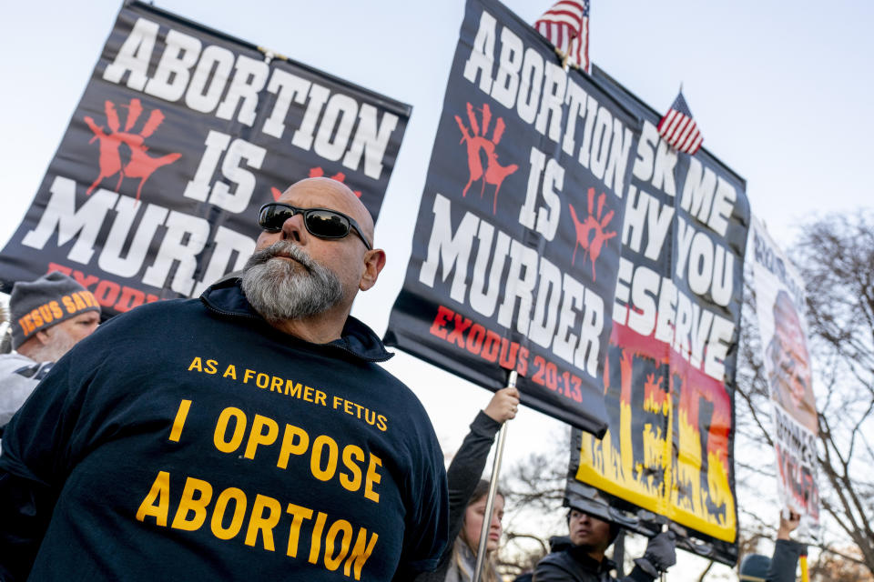 Anti-abortion protesters surround abortion rights advocates as both groups demonstrate in front of the U.S. Supreme Court, Wednesday, Dec. 1, 2021, in Washington, as the court hears arguments in a case from Mississippi, where a 2018 law would ban abortions after 15 weeks of pregnancy, well before viability. (AP Photo/Andrew Harnik)